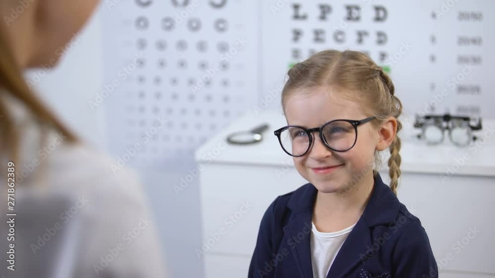 Female doctor wearing glasses on happy kid, fashion eyewear in optical store