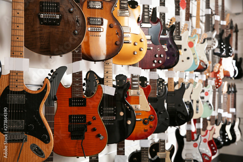 Konstfotografi Rows of different guitars in music store
