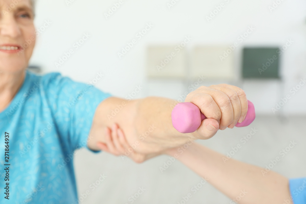 Professional physiotherapist working with elderly patient in rehabilitation center, closeup Professional physiotherapist working with elderly patient in rehabilitation center, closeup