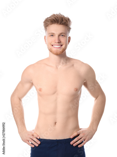 Portrait of young man with slim body on white background