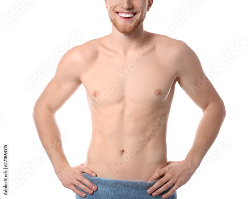 Young man with slim body in towel on white background, closeup