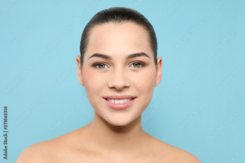 Portrait of young woman with beautiful face and natural makeup on color background Portrait of young woman with beautiful face and natural makeup on color background