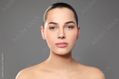 Portrait of young woman with beautiful face and natural makeup on color background © New Africa