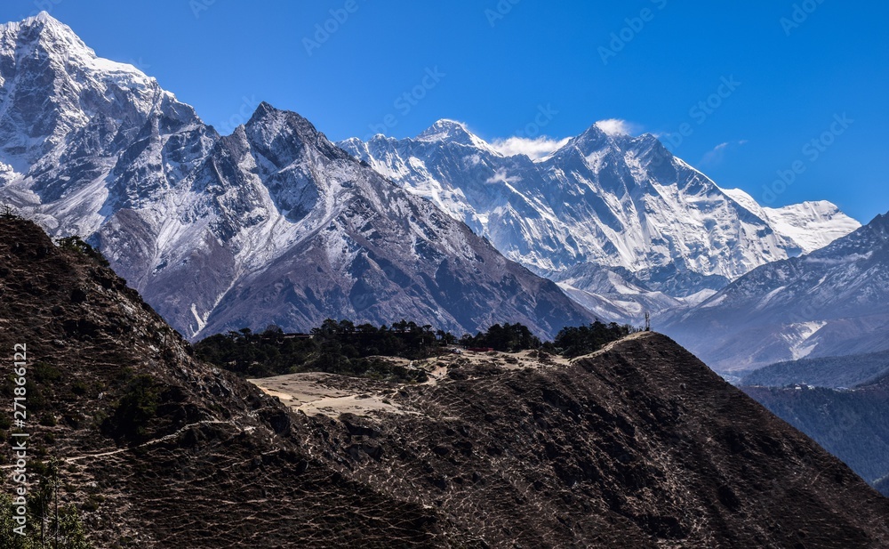Himalayas with Everest peak on center. Snow mountains on background and trekking road in front