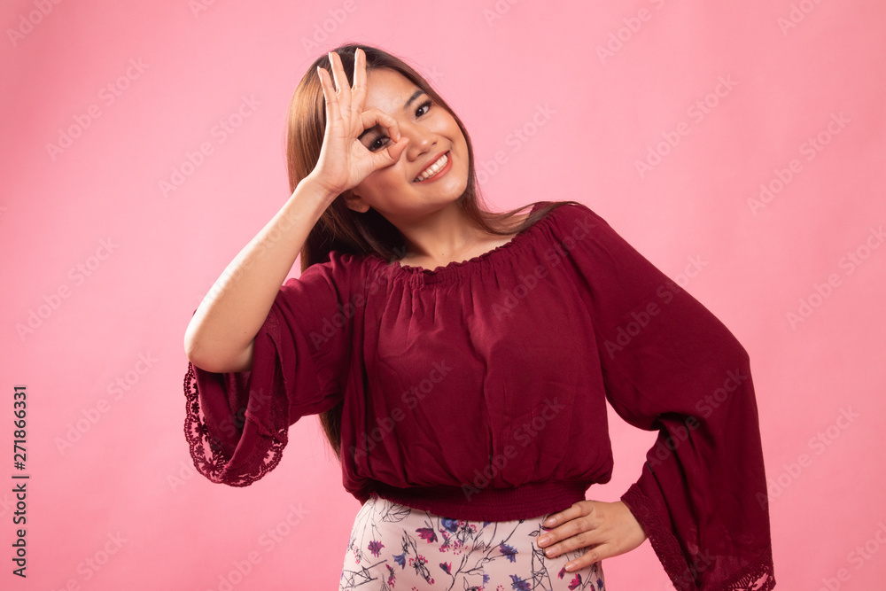 Beautiful young Asian woman show OK sign over her eye. Beautiful young Asian woman show OK sign over her eye.
