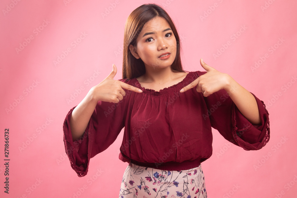 Young Asian woman point at herself ask why me. Young Asian woman point at herself ask why me.