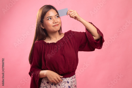 Happy young Asian woman with a blank card.