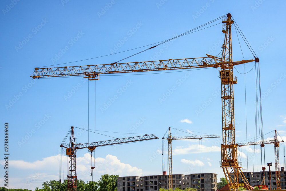 construction site of a residential multi-storey building with tower cranes construction site of a residential multi-storey building with tower cranes