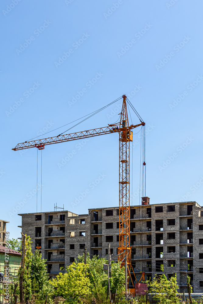 construction site of a residential multi-storey building with tower cranes
