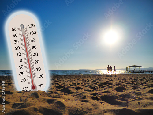 thermometer showing the temperature rise in the summer sun and seaside photo koncept