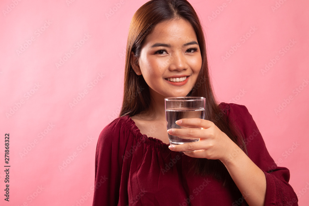 Young Asian woman with a glass of drinking water. Young Asian woman with a glass of drinking water.