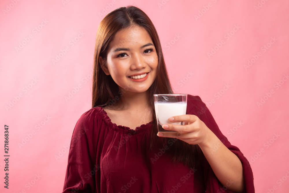 Healthy Asian woman drinking a glass of milk. Healthy Asian woman drinking a glass of milk.