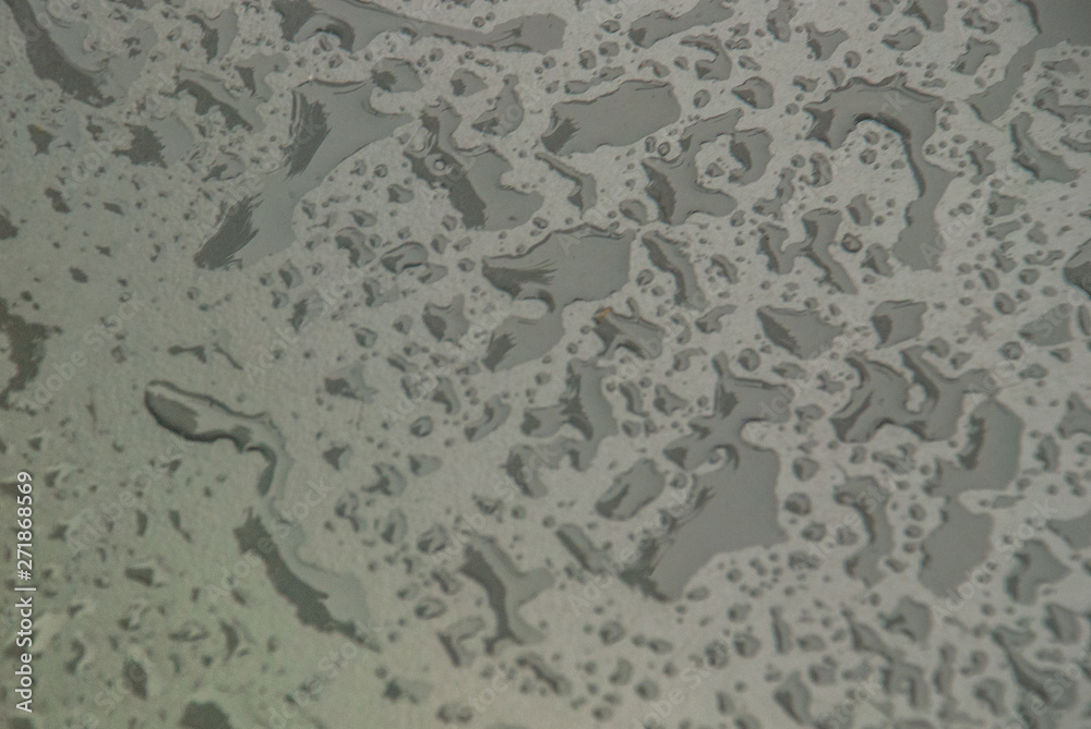Close up raining water drop on the stainless steel, surface after rainy for background or graphic design. Close up raining water drop on the stainless steel, surface after rainy for background or graphic design.