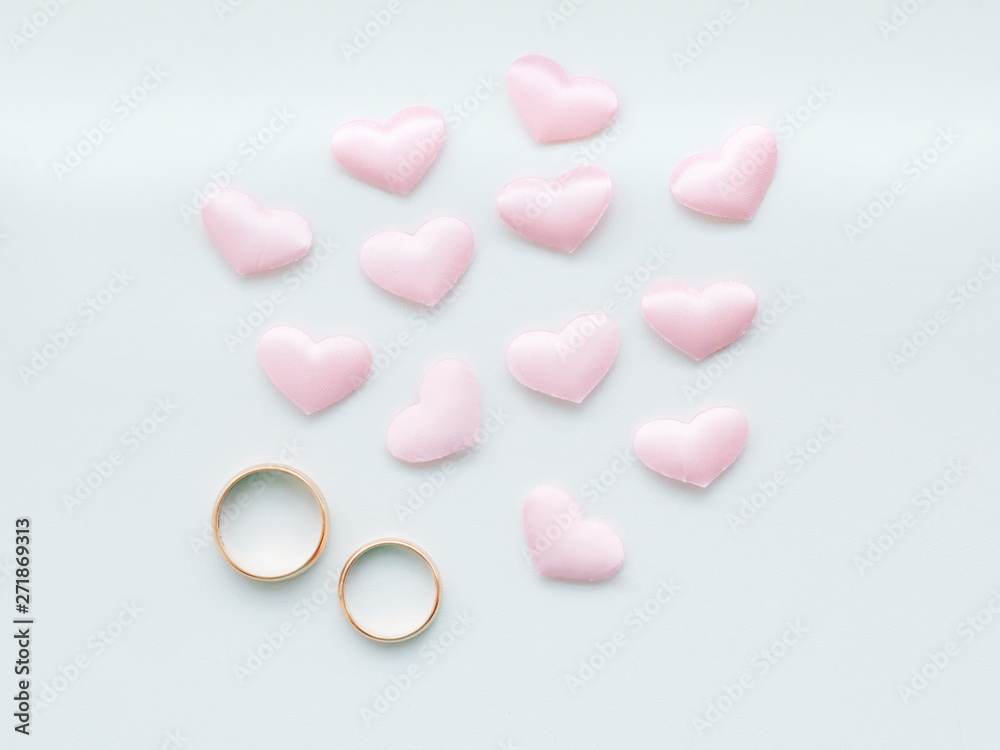 Wedding rings on a white background in pink hearts Wedding rings on a white background in pink hearts