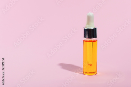 Dropper glass Bottle Mock-Up. Serum skin care cosmetics on pink background, banner or template. Beauty product concept.