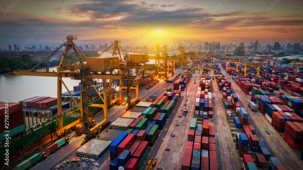 Logistics and transportation of Container Cargo ship and Cargo plane with working crane bridge in shipyard at sunrise, logistic import export and transport industry background Logistics and transportation of Container Cargo ship and Cargo plane with working crane bridge in shipyard at sunrise, logistic import export and transport industry background
