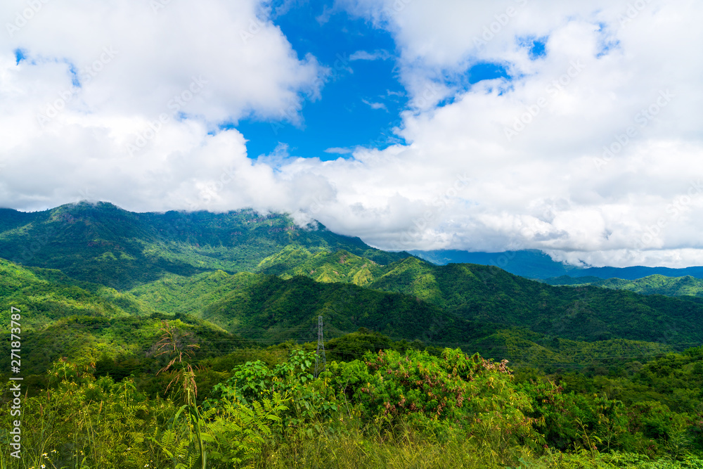 Fototapeta premium Blue sky high peak mountains fog hills mist scenery national park views at Phu Tub Berk, Khao Koh, Phetchabun Province, Thailand