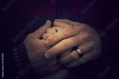 Couple holding hands up close