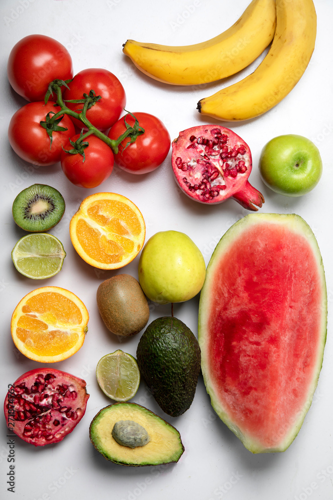 Naklejka premium Colourful collection of fruit with watermelon, oranges, apple, avacado, tomatoes, limes and bananas
