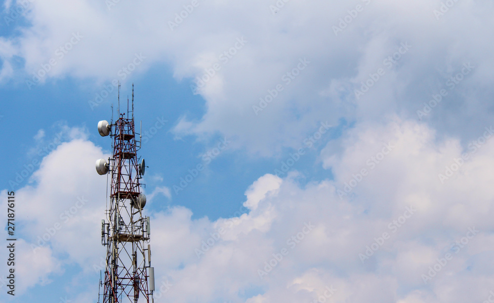 Electronic signal pole with cloud and blue sky background.