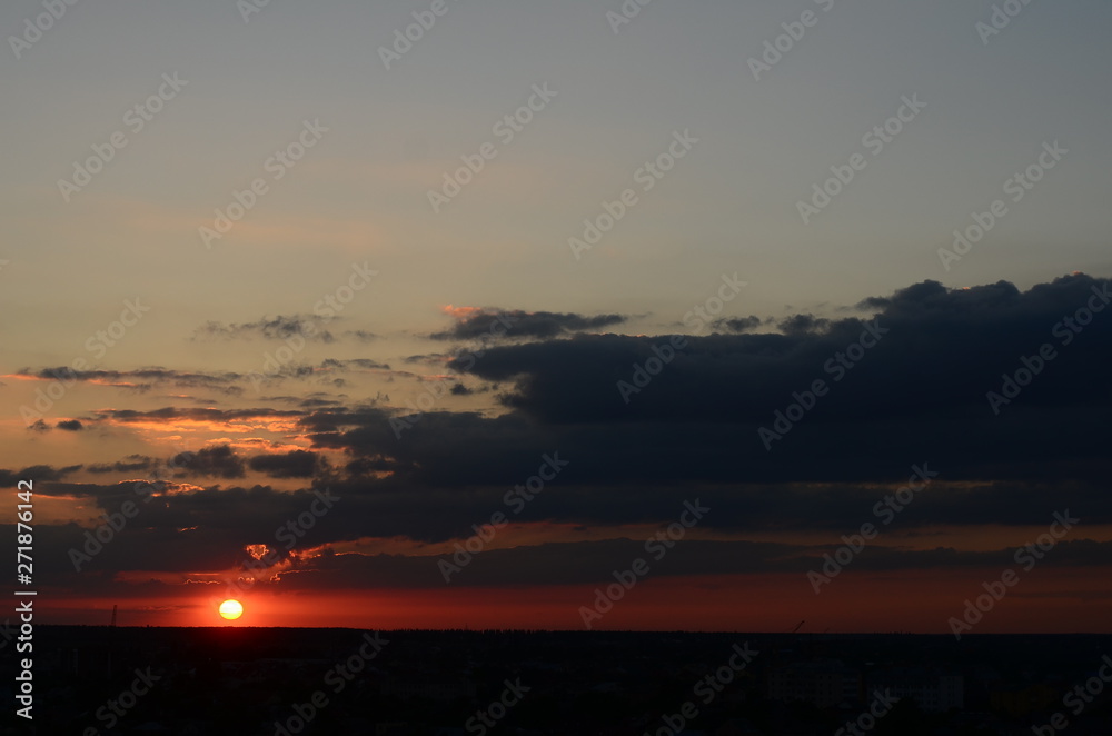 Natural Sunset Sunrise Over Field Or Meadow. Bright Dramatic Sky And Dark Ground. Countryside Landscape Under Scenic Colorful Sky At Sunset Dawn Sunrise. Sun Over Skyline, Horizon. Warm Colours.