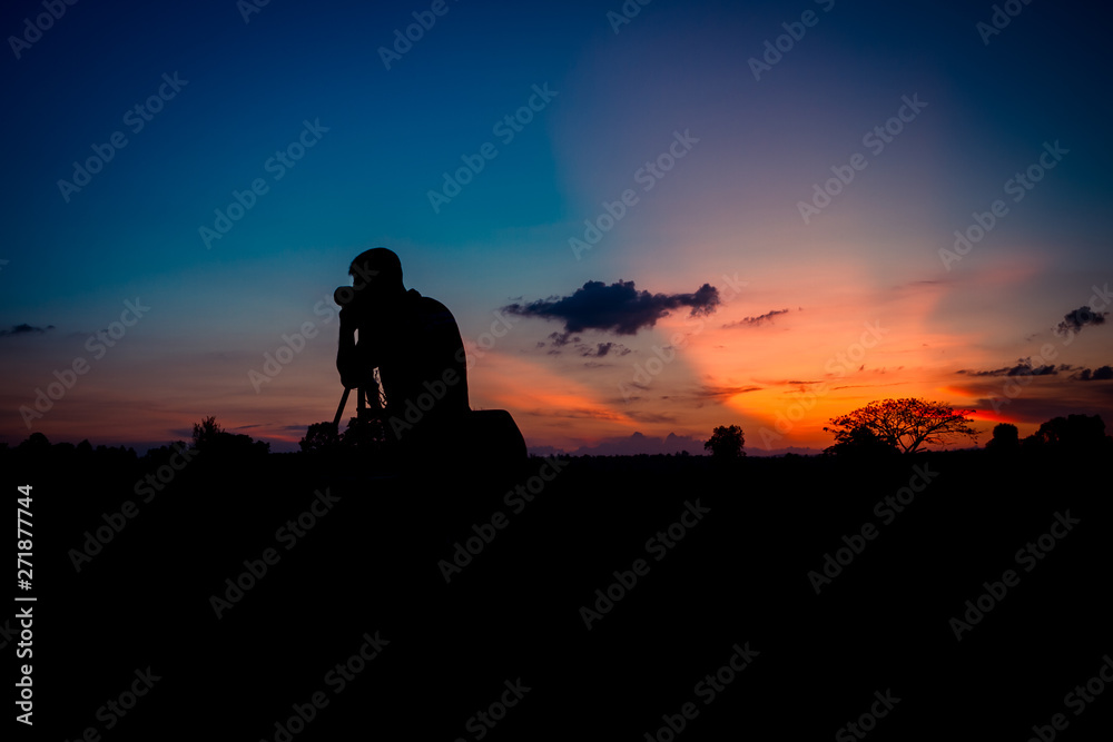 Silhouette photographer with sunset
