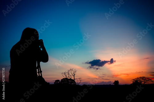 Silhouette photographer with sunset