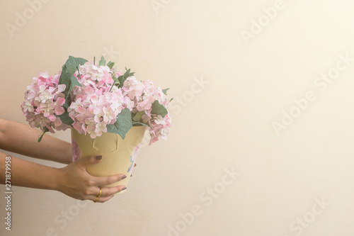 Hand hold buckets of fabric pink flowers
