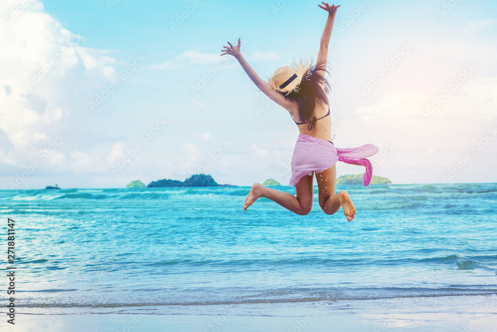 Sexy woman freedom vacation relax on the beach enjoy by run and jumping into the sea