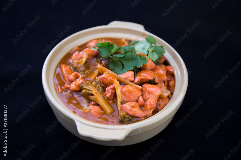 Butter chicken curry with Broccoli in Bowl Butter chicken curry with Broccoli in Bowl