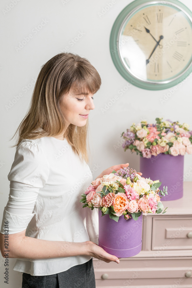 Florist holding a bouquet. Beautiful spring flowers in head box. Arrangement with mix flowers. The concept of a flower shop, a small family business. Work florist. Florist holding a bouquet. Beautiful spring flowers in head box. Arrangement with mix flowers. The concept of a flower shop, a small family business. Work florist.