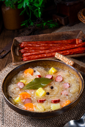 rustic sauerkraut soup with bacon and sausage photo