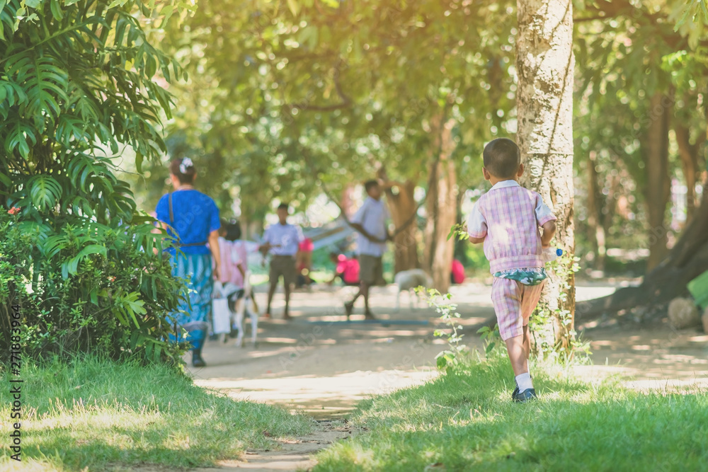 Kindergarten boy walk after female teacher and his friends back to class after having lunch. Kindergarten boy walk after female teacher and his friends back to class after having lunch.
