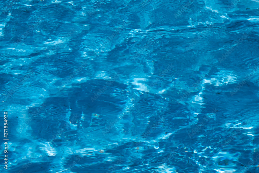Blue and bright ripple water surface in swimming pool with sun reflection. Blue and bright ripple water surface in swimming pool with sun reflection.