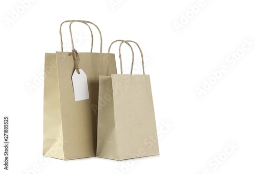 Brown shopping bags and blank tag isolated on white