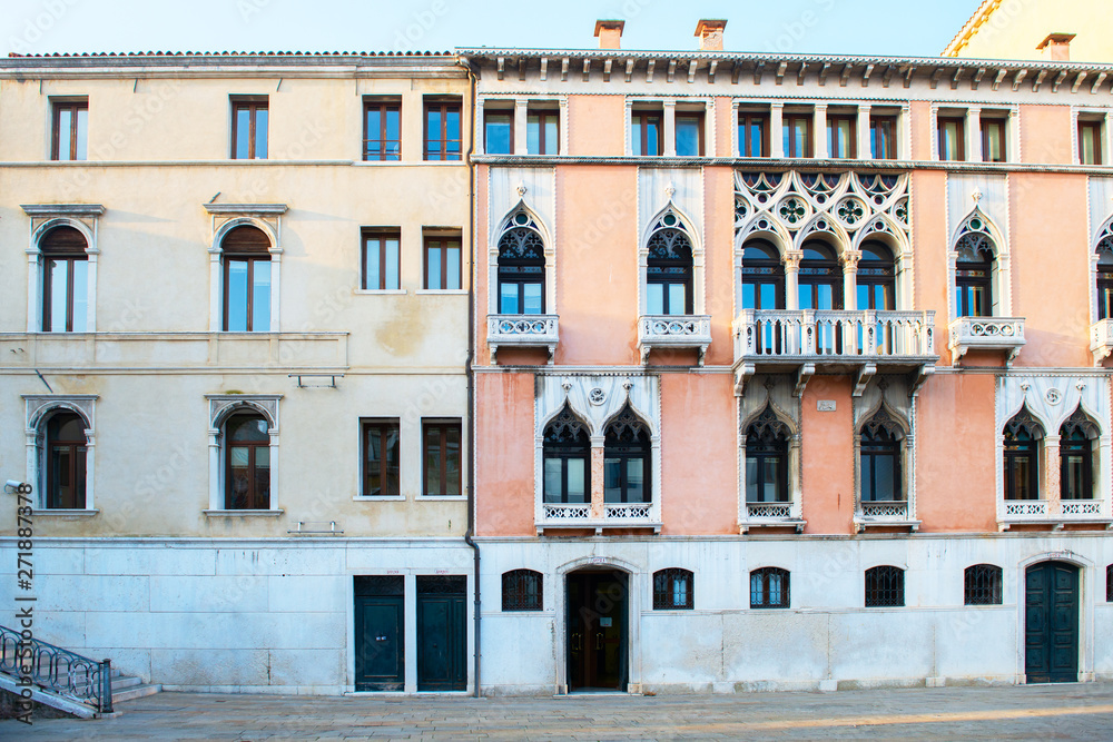 Square in Venice with ancient palace with a beautiful facade with carved balconies, Italy, Europe. Square in Venice with ancient palace with a beautiful facade with carved balconies, Italy, Europe.