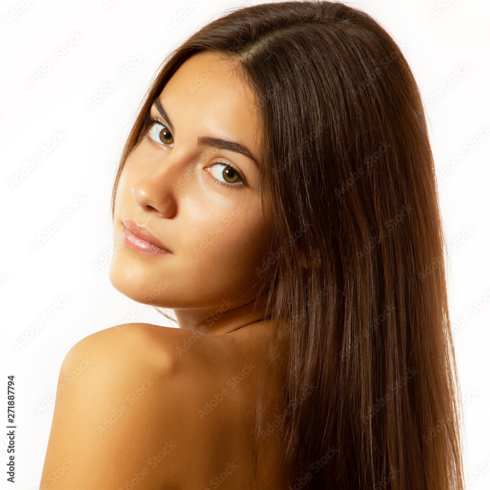Beauty feminine portrait of female face with healthy natural skin. Beautiful tanned teen girl with long brown hair looking at camera. Pretty attractive young woman posing at studio, isolated on white Beauty feminine portrait of female face with healthy natural skin. Beautiful tanned teen girl with long brown hair looking at camera. Pretty attractive young woman posing at studio, isolated on white
