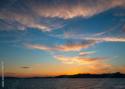 Panoramic view of Mediterranean sea, sky and sun at golden sunset in Palma de Mallorca, Spain.