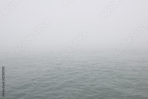 Mediterranean sea in fog. Foggy weather near italian island Burano, province of Venice, Italy.