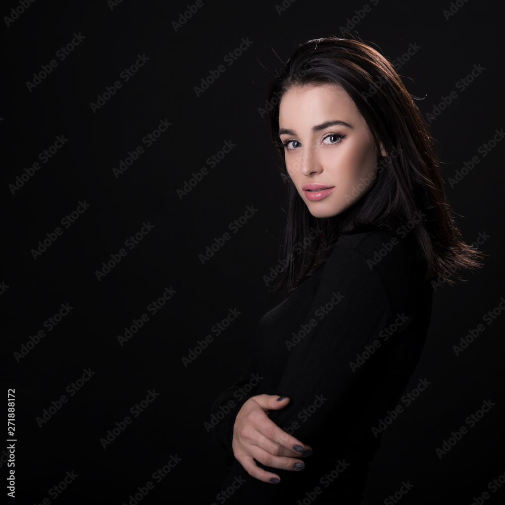Beautiful girl posing over black background. Young pretty woman in studio. Beautiful girl posing over black background. Young pretty woman in studio.