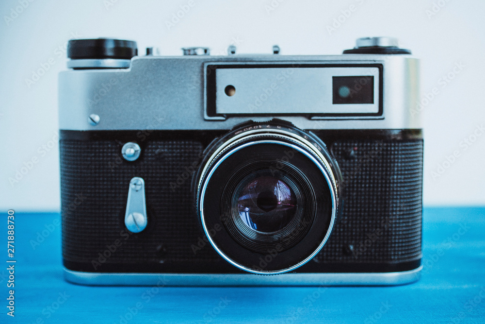  Film camera on a blue background. Retro camera.