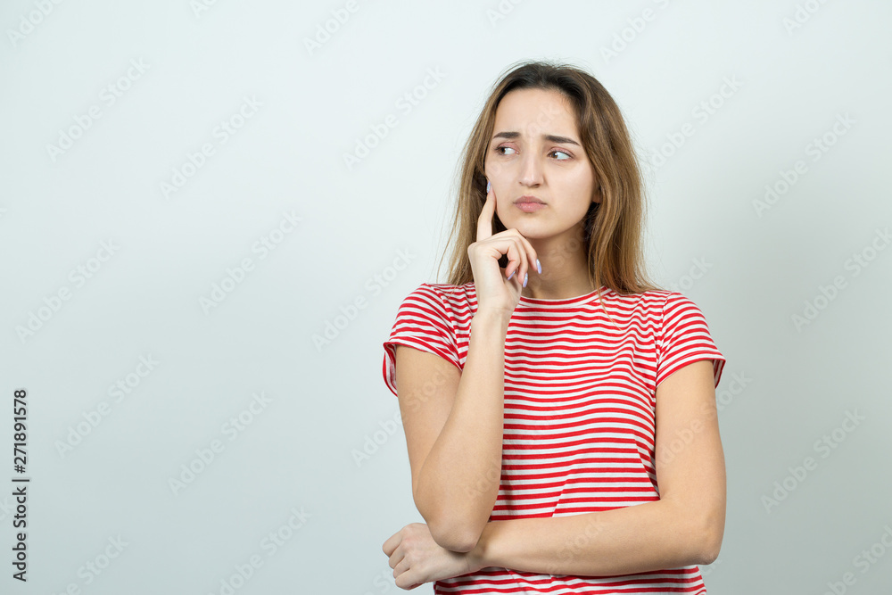 Emotional portrait of a fair-haired girl on a gray background, stormy emotions, business concept. Emotional portrait of a fair-haired girl on a gray background, stormy emotions, business concept.