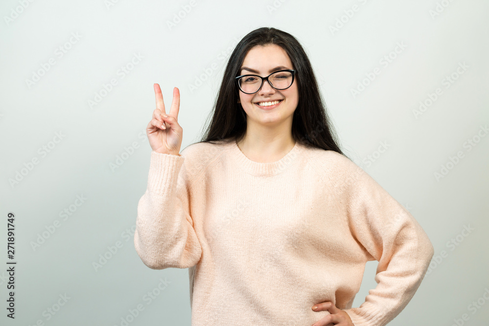 Emotional portrait of a dark-haired girl on a gray background, stormy emotions, business concept. Emotional portrait of a dark-haired girl on a gray background, stormy emotions, business concept.