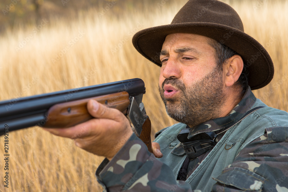 Hunter with a hat and a gun in search of prey in the steppe Hunter with a hat and a gun in search of prey in the steppe