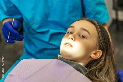 Dental clinic. Reception  examination of the patient. Teeth care. Young woman undergoes a dental examination by a dentist