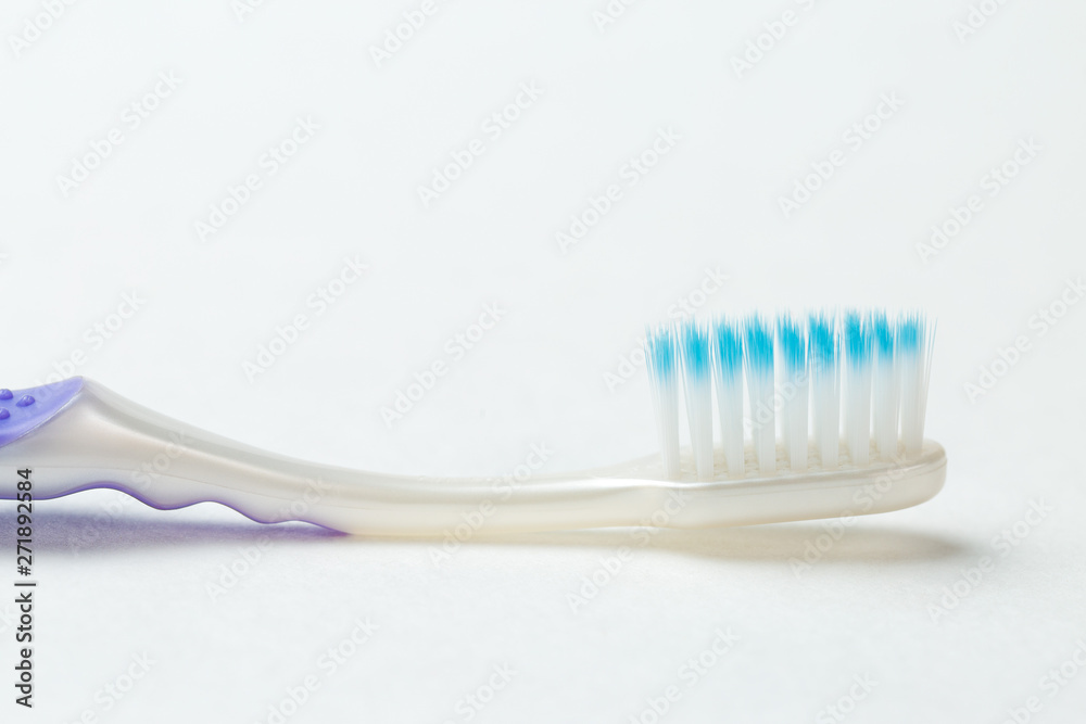 Purple new toothbrush close-up on white background Purple new toothbrush close-up on white background