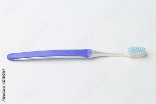 Purple new toothbrush close-up on white background