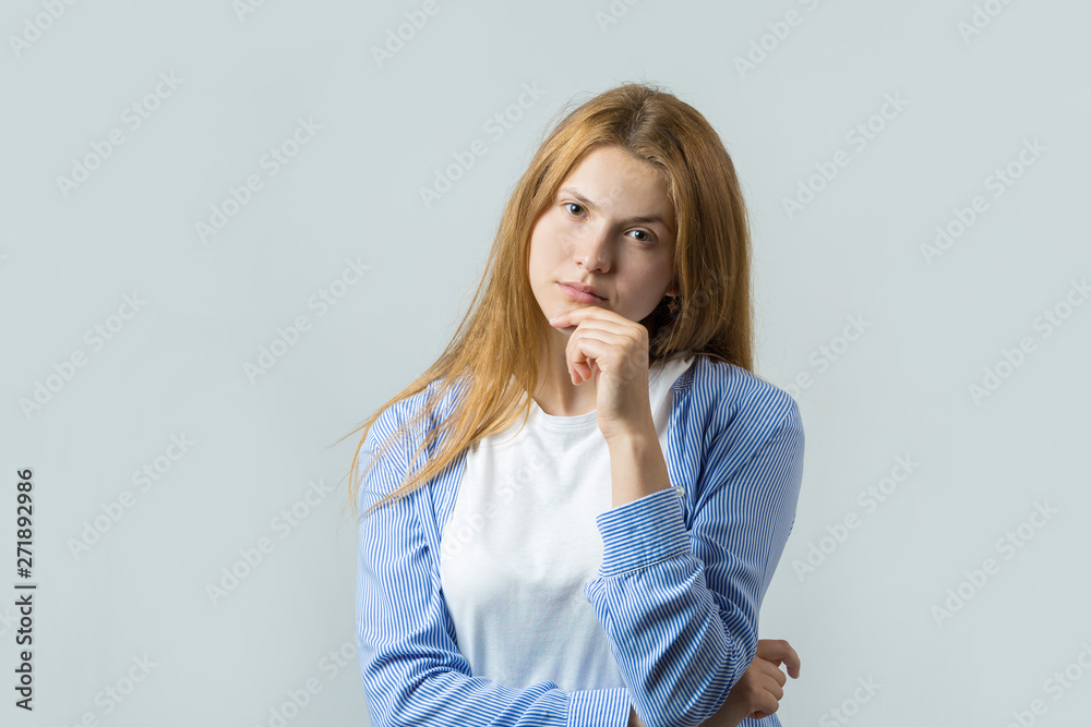 Emotional portrait of a red-haired girl on a gray background, stormy emotions, business concept. Emotional portrait of a red-haired girl on a gray background, stormy emotions, business concept.