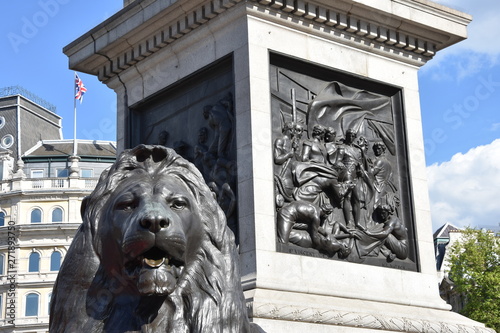 One of the four lion sculptures designed by the artist Sir Edwin Landseer emplaced at the foot of Nelson's Column in 1867 in Trafalgar Square, London, UK photo