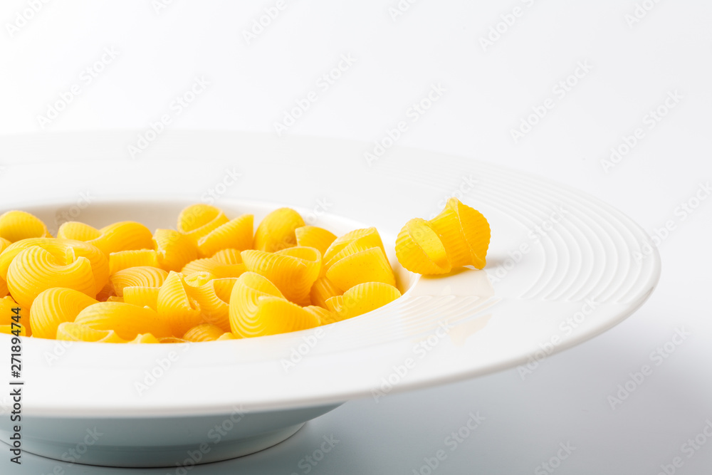 Raw elbow Macaroni (Gomiti Pasta) in bowl Raw elbow Macaroni (Gomiti Pasta) in bowl